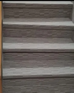 Detailní textura a lícování vzoru krytiny Flotex na schodišťových stupních – precizní práce, kterou odvádějí ostravští mistři podlahových systémů pro Viva Floors.