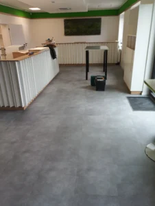Celkový pohled na hotovou vinylovou podlahu Gerflor Creation 55 na recepce s bílým nábytkem v Ostravě